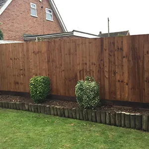 a wooden fence in a back yard