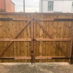 a large wooden gate with metal handles
