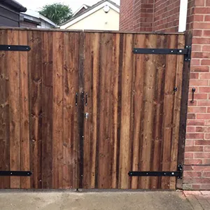 a wooden gate with metal bars on top of it