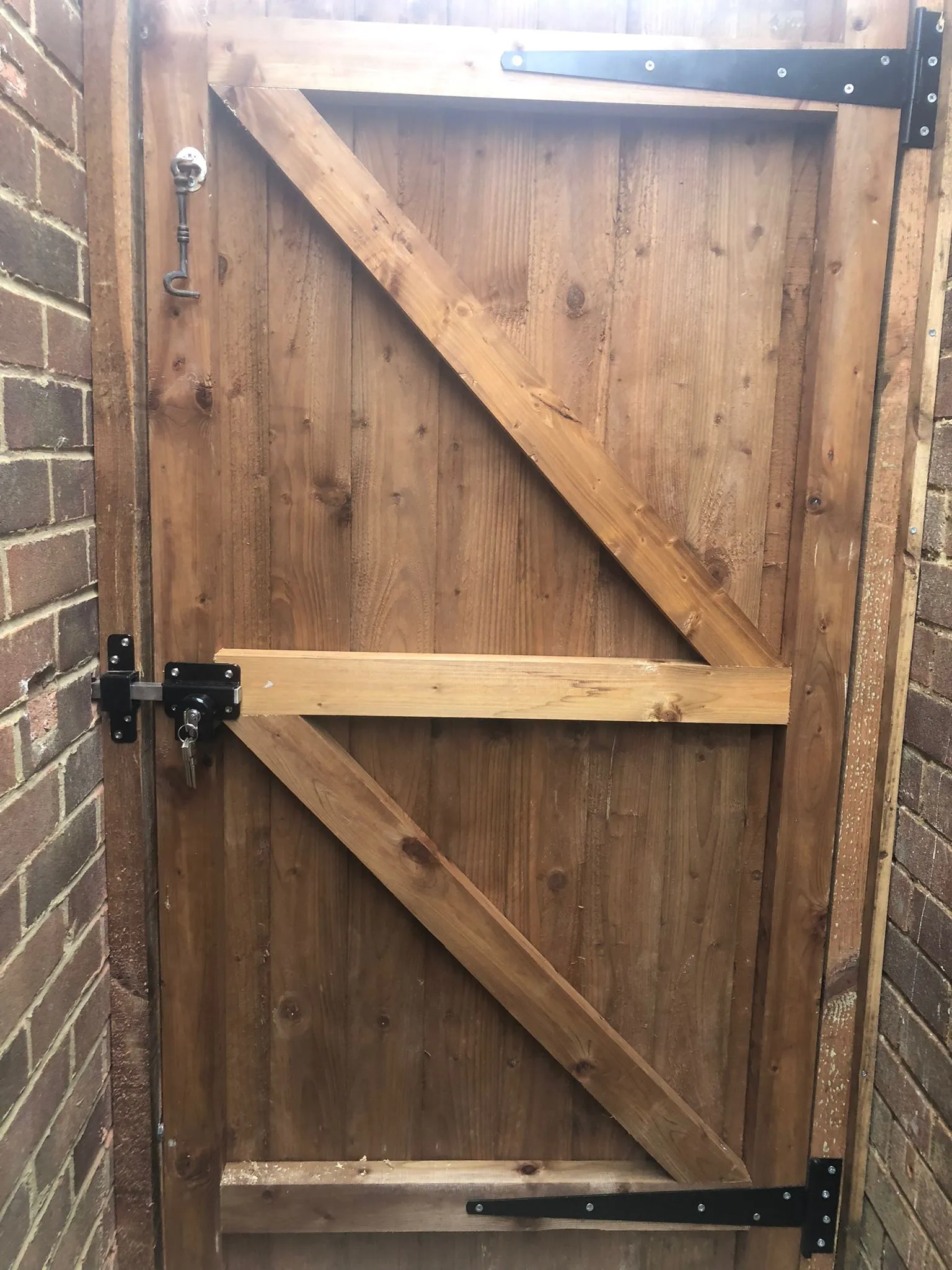 a close up of a wooden door on a brick wall